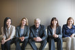 © Martin Barraud/Caia Image - Portrait smiling business people in a row on sofa