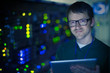 © Tom Merton/Caia Image - Portrait confident server room technician with digital tablet