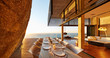© Chris Ryan/Caia Image - Modern luxury patio dining table with sunset ocean view