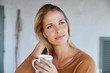 © Ryan Lees/Caia Image - Serene woman drinking coffee