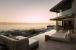 © Tom Merton/Caia Image - Tranquil sunset ocean view beyond modern luxury home showcase patio