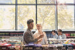 © Tom Merton/Caia Image - Young couple using cell phone in grocery store market
