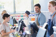 © Tom Merton/Caia Image - Portrait smiling, confident young male cashier working at grocery store market checkout