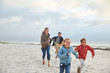 © Ryan Lees/Caia Image - Playful family running on winter beach