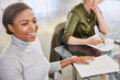 © Ryan Lees/Caia Image - Smiling businesswoman with paperwork in meeting