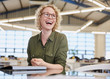 © Ryan Lees/Caia Image - Laughing businesswoman in office
