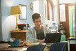 © Justin Pumfrey/Caia Image - Young man college student studying at laptop