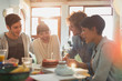© Justin Pumfrey/Caia Image - Young couple friends celebrating birthday with cake and candle
