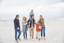Multi-generation Family Walking On Winter Beach