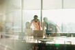 © Tom Merton/Caia Image - Business people working at laptop in conference room meeting