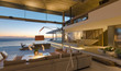 © Tom Merton/Caia Image - Illuminated modern, luxury home showcase interior living room with ocean view at dusk