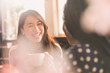 © Tom Merton/Caia Image - Laughing women talking and drinking coffee in cafe