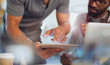 © Tom Merton/Caia Image - Close up businessmen using digital tablet
