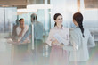 © Tom Merton/Caia Image - Businesswomen with paperwork talking in office