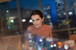 © Tom Merton/Caia Image - Businesswoman working late at laptop in office at night