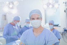 Portrait Confident Young Male Surgeon Wearing Surgical Mask In Operating Room