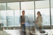 © Tom Merton/Caia Image - Smiling businessman leading conference room meeting