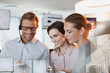 © Tom Merton/Caia Image - Business people using digital tablet in office