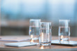 © Tom Merton/Caia Image - Water in glasses next to digital tablets on table