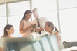 © Tom Merton/Caia Image - Business people texting with cell phones in sunny conference room meeting