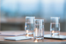Water In Glasses Next To Digital Tablets On Table