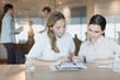 © Tom Merton/Caia Image - Businesswomen reviewing paperwork in conference room meeting