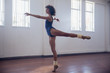 © Sam Edwards/Caia Image - Graceful young female dancer practicing in dance studio