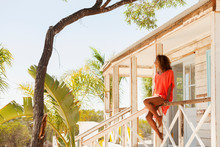 Young, Serene Woman Relaxing On Sunny Beach Hut Patio