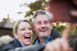 © Sam Edwards/Caia Image - Happy, playful mature couple taking selfie