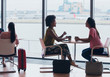 © Robert Daly/Caia Image - Businesswomen talking and drinking coffee in airport business lounge