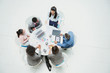 © Robert Daly/Caia Image - High angle view businesswoman leading meeting at round table
