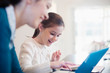 © Sam Edwards/Caia Image - Smiling girl using laptop