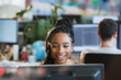 © Tom Merton/Caia Image - Smiling businesswoman with headset working at computer in office