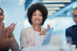 © Robert Daly/Caia Image - Confident businesswoman clapping in conference room meeting