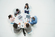High angle view businesswoman leading meeting at round table