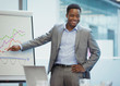 © Robert Daly/Caia Image - Smiling businessman at flip chart leading conference room meeting