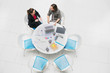 © Robert Daly/Caia Image - High angle view businesswomen talking, meeting at round table