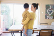 © Sam Edwards/Caia Image - Mother holding baby son in dining room