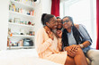 © Paul Bradbury/Caia Image - Affectionate multi-generation family hugging on bed
