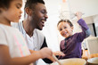 © Sam Edwards/Caia Image - Playful father and sons baking in kitchen