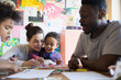 © Sam Edwards/Caia Image - Family coloring at table