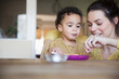 © Sam Edwards/Caia Image - Mother feeding baby son at table