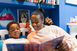 © Paul Bradbury/Caia Image - Mother and son reading book