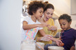 © Sam Edwards/Caia Image - Playful mother and children baking in kitchen