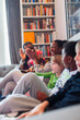 © Paul Bradbury/Caia Image - Happy family clapping on living room sofa