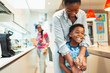 © Paul Bradbury/Caia Image - Affectionate mother and son hugging in kitchen