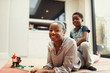 © Paul Bradbury/Caia Image - Portrait happy mother and son on living room sofa