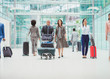 © Robert Daly/Caia Image - Business people walking with luggage in airport