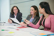 © Robert Daly/Caia Image - Businesswomen discussing paperwork in conference room meeting