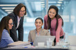 © Robert Daly/Caia Image - Smiling businesswomen using laptop in conference room meeting
